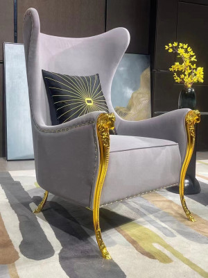 Luxurious armchair with decorative elements and gold-plated legs